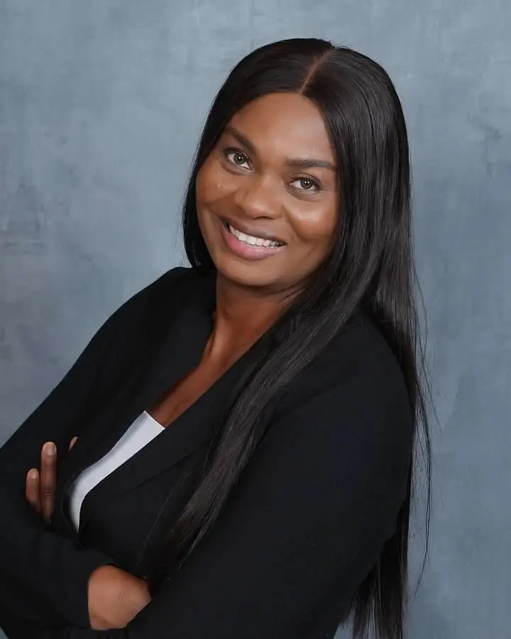 A woman with long black hair posing for the camera.